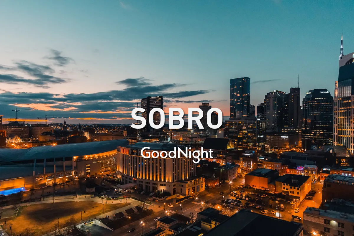 A sweeping view of the Nashville skyline at sunset, with illuminated buildings signaling the city coming alive for the evening. Rooftop restaurants and bars are visible, and the overall atmosphere is energetic and lively—perfect for nightlife and music exploration.