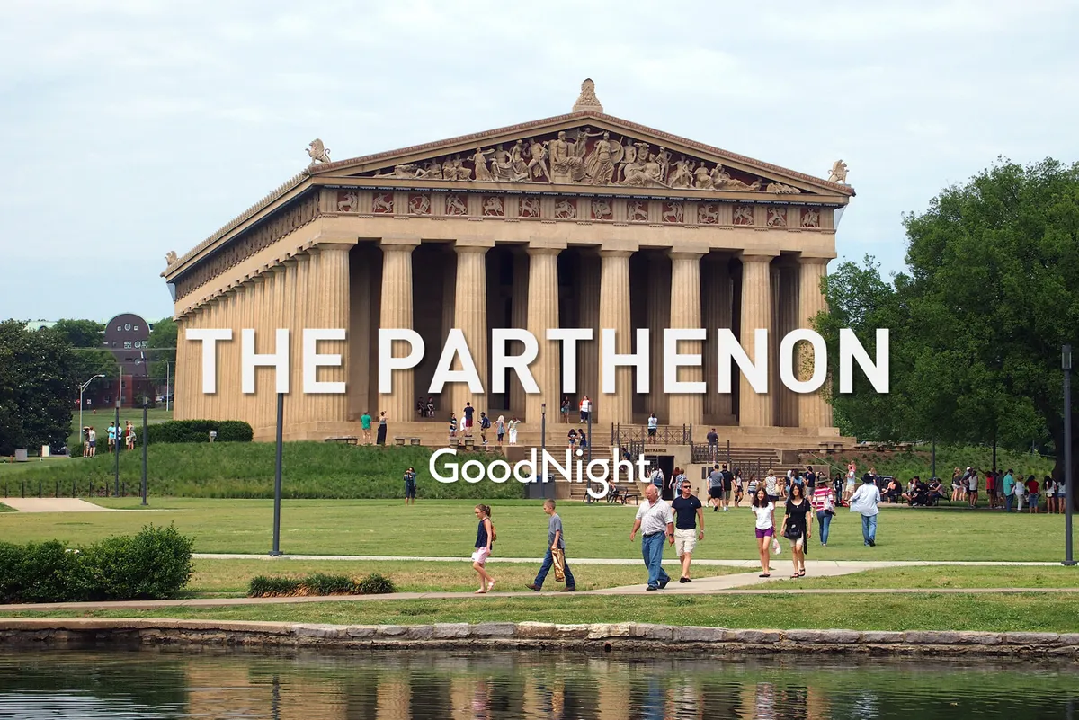 The image shows the iconic Parthenon set within lush greenery at Centennial Park. People are gathered on the grass, socializing, walking, and capturing photos, with their reflections visible in the water. The atmosphere is festive, highlighting the park as a vibrant community hub.